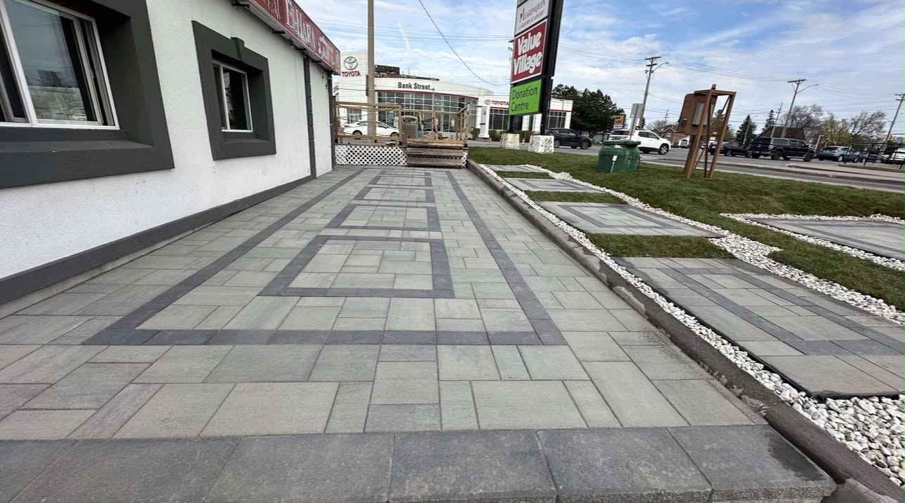 Banded grey and charcoal plaza paving along a commercial storefront on Bank Street