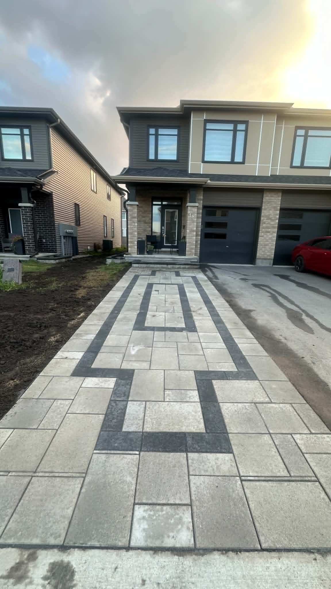 Light front walk with a dark double-band inlay pattern leading to a covered porch